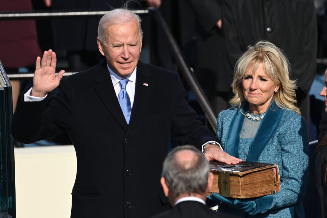 Joe Biden, alongside incoming US First Lady Jill Biden, is sworn in as the 46th US President by Supreme Court Chief Justice John Roberts.