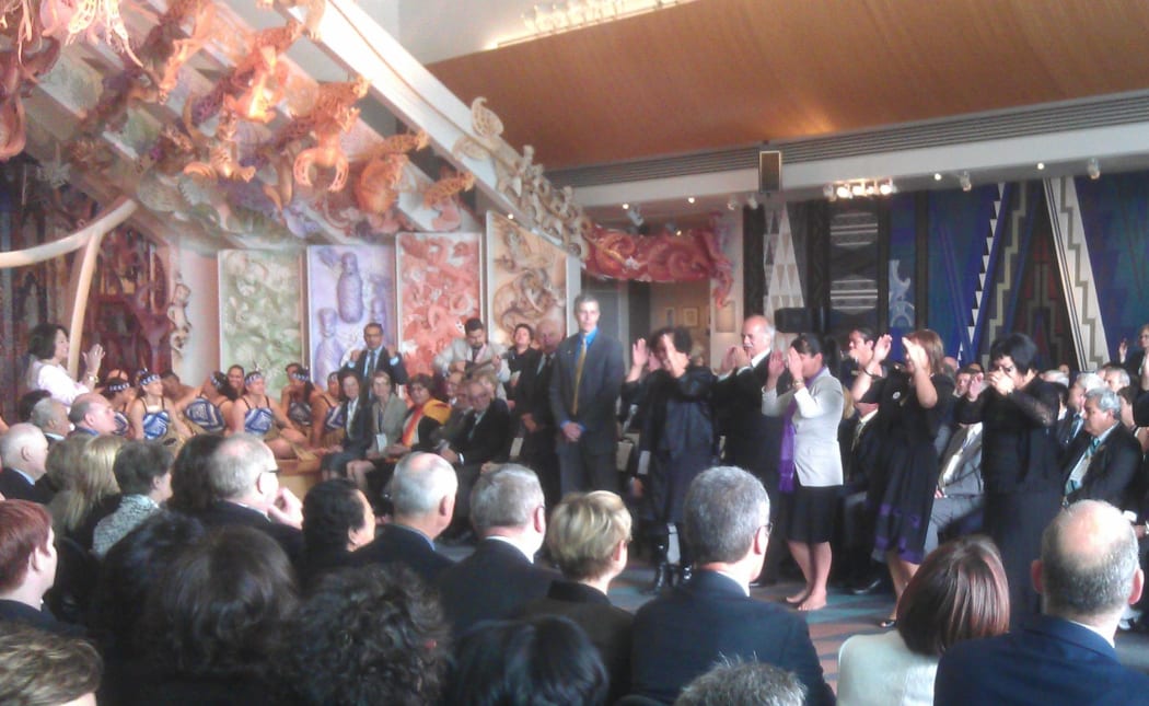 US Secretary for Education Arne Duncan (standing in centre) watches as a waiata is performed.