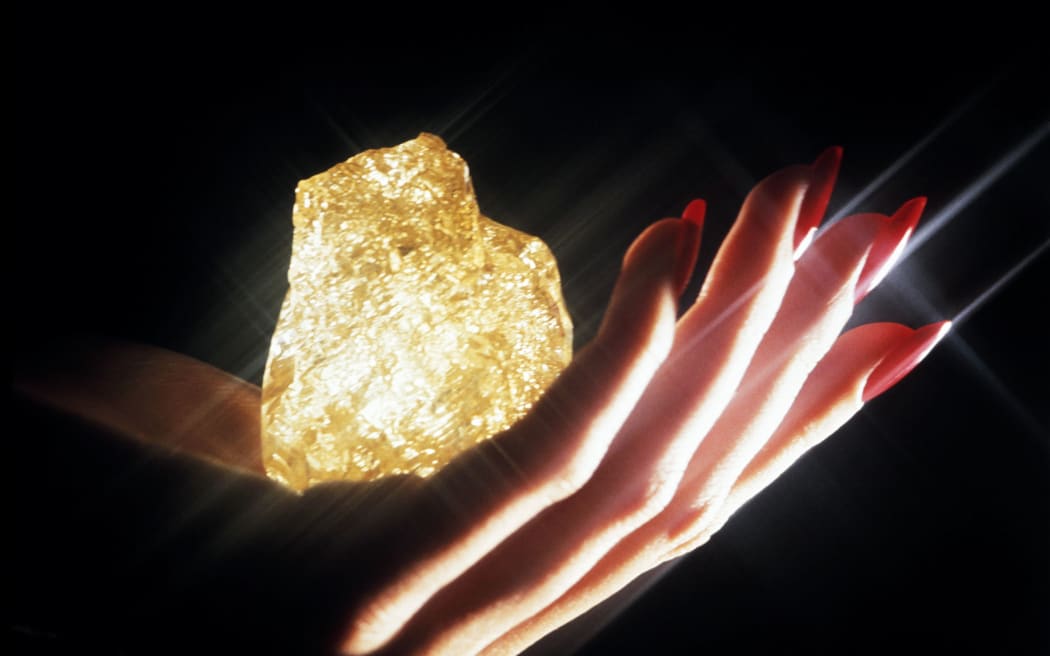 1984 photo of the Zale diamond, largest diamond-in-the-rough in the world, weighing 890 carats with an irregular shape and yellow colour.