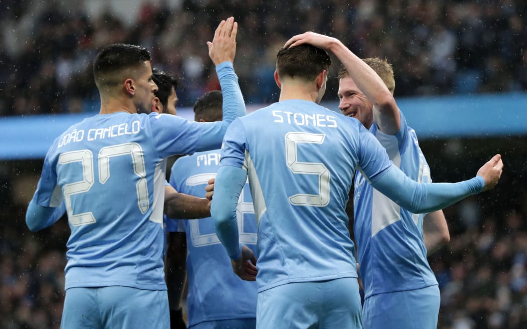 Kevin de Bruyne celebrates with  Manchester City teammates.