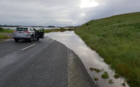 A road to Henley is cut off after heavy rain flooded Otago.