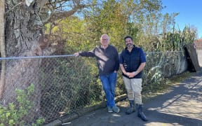 Peter Nelson (left) and Dion Pou, next to the creek in Te Atatū that Auckland Council plans to turn into part of a stormwater pipe.