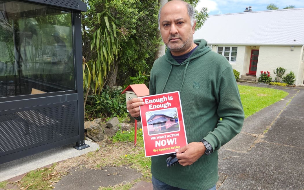Dairy and Business Association chair Sunny Kaushal holds a leaflet calling for tougher action on crime, following the fatal stabbing dairy worker Janak Patel.