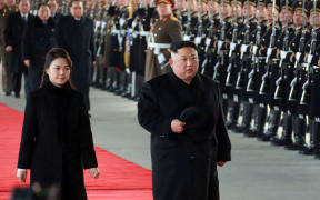North Korean leader Kim Jong-un (right) and his wife Ri Sol-Ju leaving Pyongyang Station to visit China.