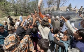 Displaced Afghan families flee northern provinces due to clashes between Taliban and Afghan security as they seek refuge inside a park with harsh conditions in Kabul, Afghanistan, on August 10, 2021.