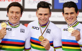 The New Zealand track cycling world sprint champions Ethan Mitchell, Eddie Dawkins and Sam Webster with their gold medals and world champion rainbow jerseys.