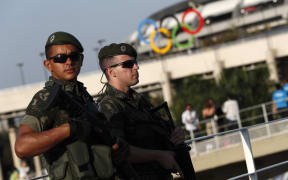 Brazilian security forces stand guard outside the Maracana stadium in Rio de Janeiro, ahead of the opening ceremony.