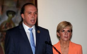 Australian Immigration Minister Peter Dutton (L) and Australian Foreign Minister Julie Bishop address journalists during a press conference in Nusa Dua, Bali on March 23, 2016.