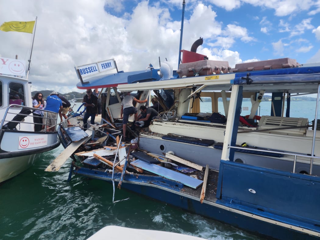 Passengers on the stricken Blue Ferry clamber over wreckage to the safety of the Happy Ferry while others tend to the injured skipper.