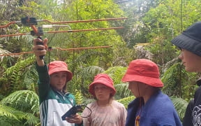 Evelyn Colegate and class mates from Oakura School search for signals to track kiwi's movements