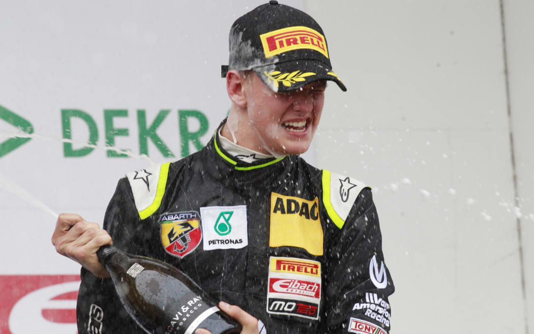 Mick Schumacher sprays champagne