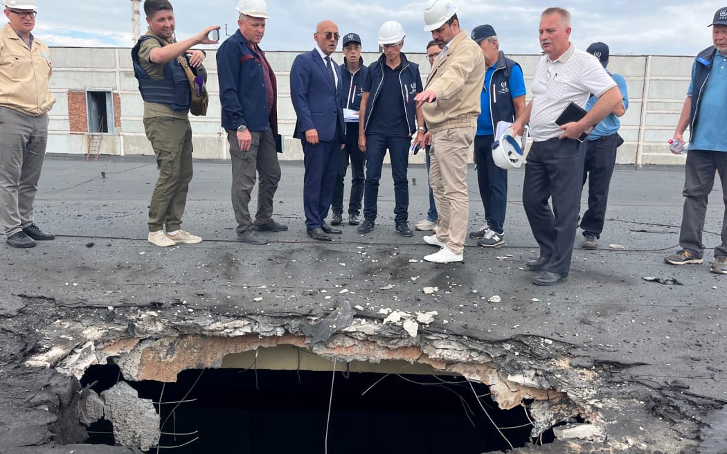 The International Atomic Energy Agency (IAEA) IAEA team, including chief Rafael Grossi (centre), at the Zaporizhzhia Nuclear Power Plant observing damage from shelling on the roof of the special building which houses fresh nuclear fuel and the solid radioactive waste storage facility, 1 September, 2022
