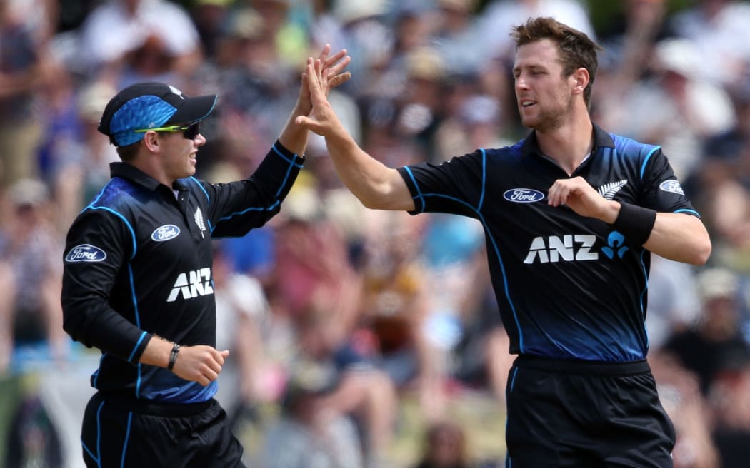 Tom Latham (L) and Matt Henry (R) celebrate the wicket of Lahiru Thirimanne during the fifth one day international cricket match between New Zealand and Sri Lanka.