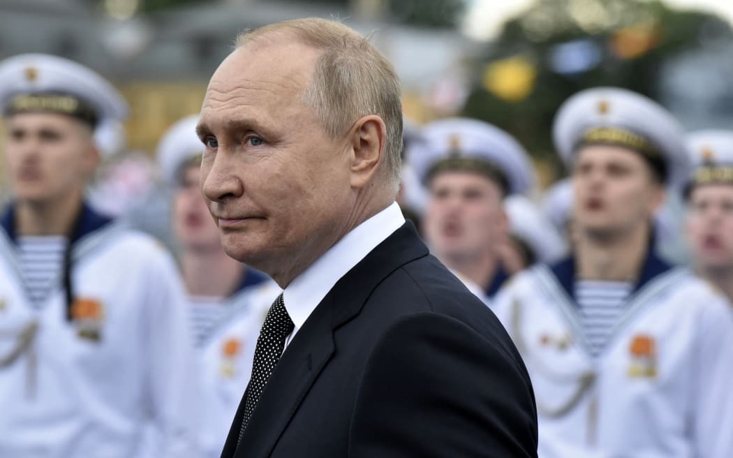 Russia's President Vladimir Putin reviews naval troops as he attends the main naval parade marking the Russian Navy Day, in St. Petersburg on 31 July, 2022.