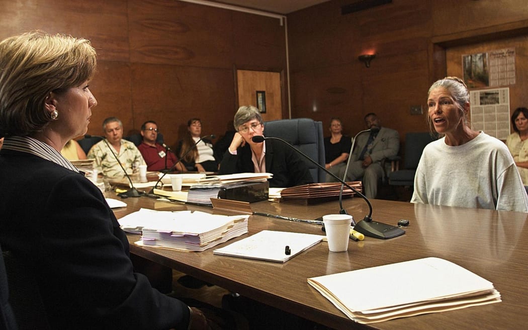 (FILES) Leslie Van Houten, a former follower of Charles Manson, listens as former Deputy District Attorney Stephen Kay (not pictured) describes the 1969 killing scene of the Smaldino couple during a parole hearing June 28, 2002 at the California Institution for Women in Corona, California. Leslie Van Houten, a disciple of notorious serial killer Charles Manson, was released from prison on July 11, 2023 after more than five decades, California prison authorities said. (Photo by DAMIAN DOVARGANES / AP / AFP)