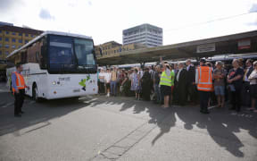 Commuters wait for buses in Wellington.