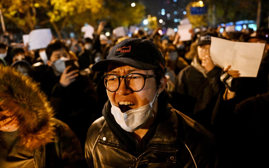 Protesters during a rally for the victims of a deadly fire as well as a protest against China's harsh Covid-19 restrictions in Beijing on 28 November, 2022.