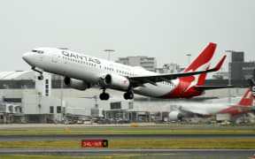 A Qantas plane takes off from the Sydney International airport on 6 May 2021.