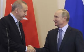 Russian President Vladimir Putin (R) and his Turkish counterpart Recep Tayyip Erdogan shake hands during a joint press conference following their talks in the Black sea resort of Sochi on October 22, 2019.