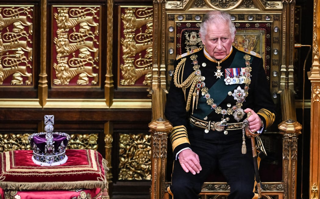 Charles, then pictured as Prince of Wales (right) by the The Imperial State Crown in the House of Lords Chamber, in the Houses of Parliament, in London, on May 10, 2022.