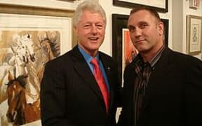 A promotional photo on the BGI Security website of Adrian Gard and former US President Bill Clinton.