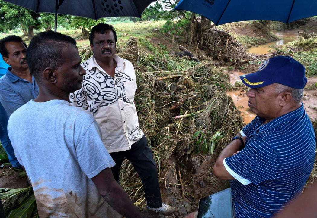 Residents of Yalalevu talk to Fiji Prime Minister Frank Bainimarama following the flood.