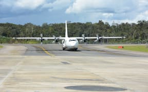 Flight arriving at Komo airfield in PNG Southern Highlands with humanitarian relief supplies