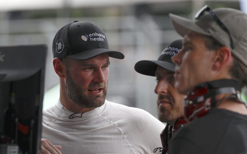 Shane Van Gisbergen works with crew in the garage area during qualifying for the NASCAR Cup Series Grant Park 220 at the Chicago Street Course.