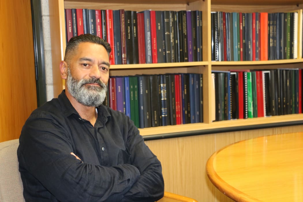 Professor Meihana Durie at his office, the books are bound PhD thesis from a range of Māori scholars.