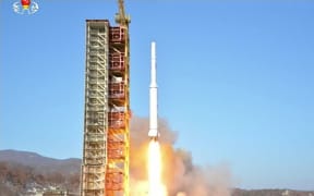 The rocket launch shown on North Korean TV.