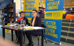 NZEI president Louise Green and PPTA president Angela Roberts announce the results of a vote in which teachers overwhelmingly opposed a proposed change to school funding.