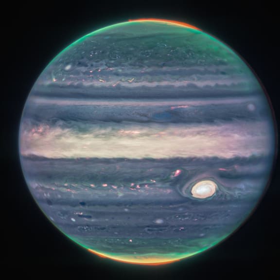 In this image obtained from NASA and taken by the James Webb Space Telescope, shows Jupiter's weather patterns, tiny moons, altitude levels, cloud covers and auroras at the northern and southern poles.  (Photo by Handout / NASA / AFP) / RESTRICTED TO EDITORIAL USE - MANDATORY CREDIT "AFP PHOTO / NASA, ESA, CSA, Jupiter ERS Team;  image processing by Judy Schmidt" - NO MARKETING NO ADVERTISING CAMPAIGNS - DISTRIBUTED AS A SERVICE TO CLIENTS