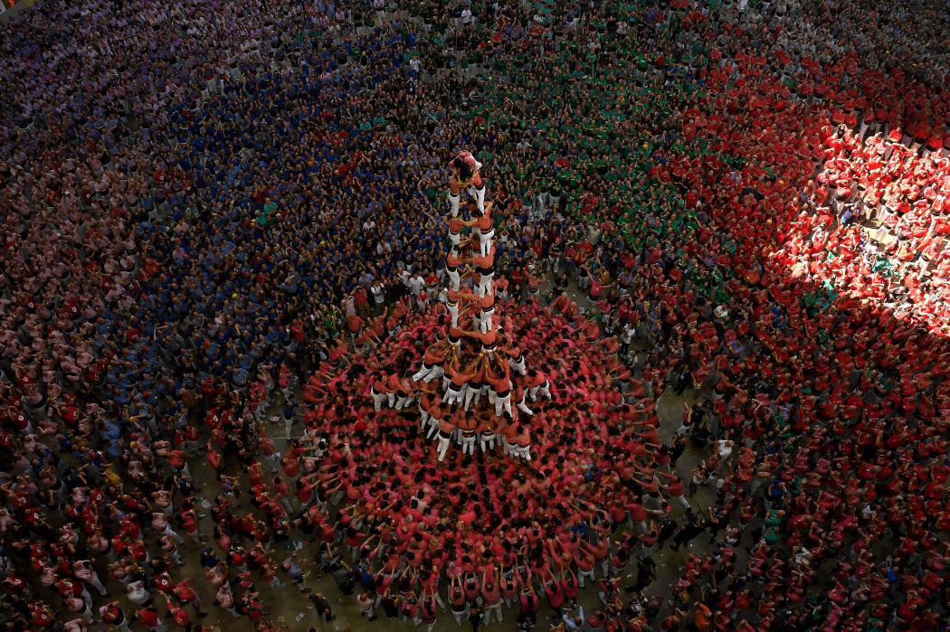 Members of the "Colla Vella dels Xiquets de Valls" human tower team form a "castell" (human tower) winning the XXVII 'castells' competetion in Tarragona on October 7, 2018.