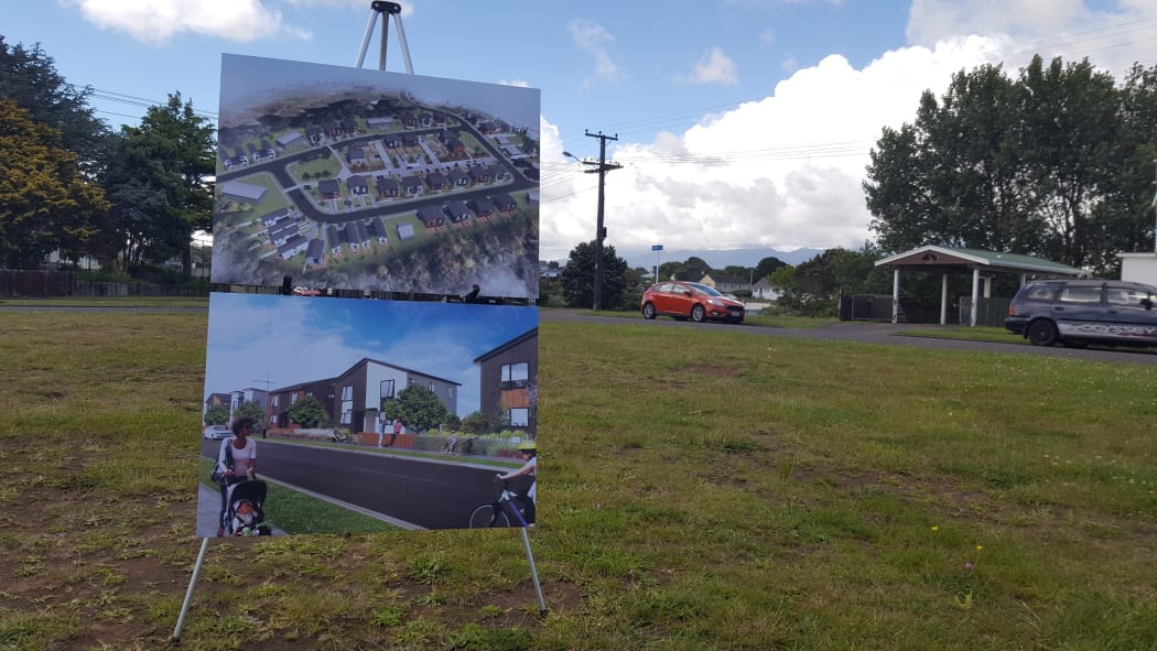 Expectation vs reality. A board displays an artist render of the Marfell KiwiBuild project.