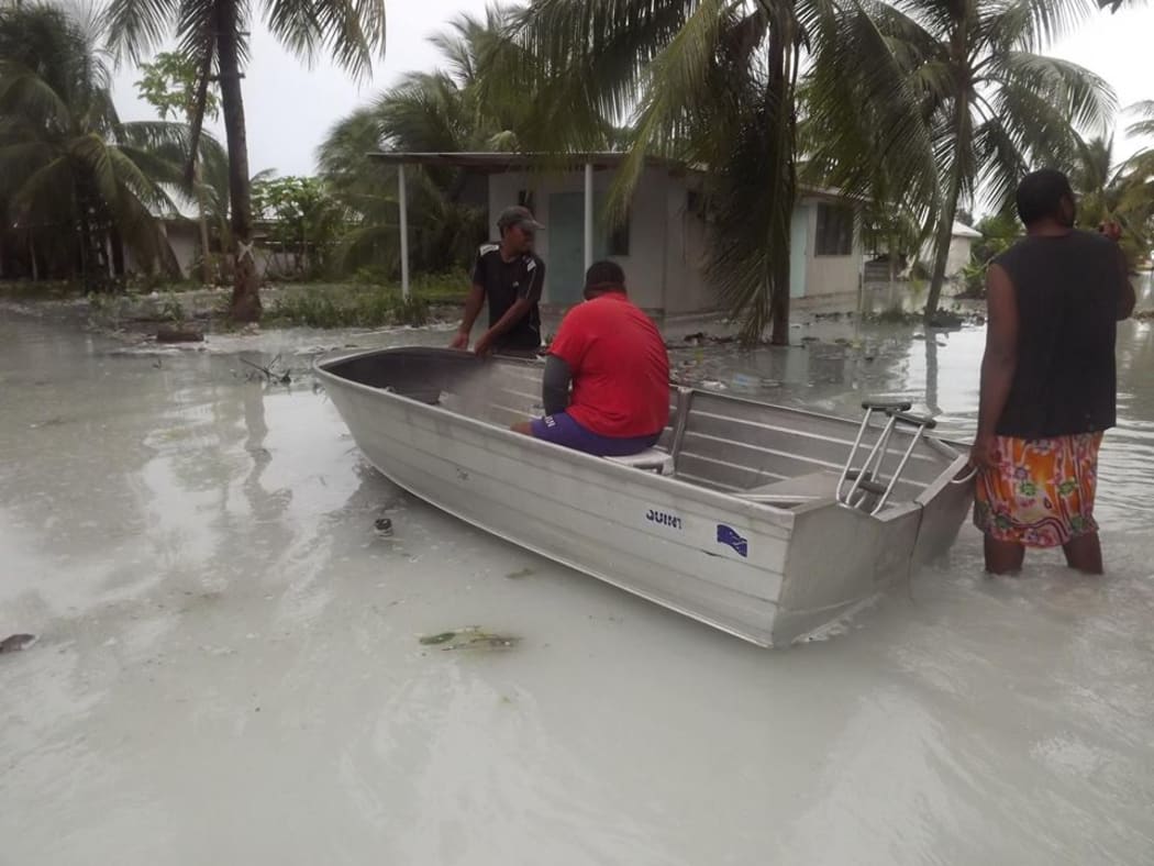 Tuvalu - locals assessing damage following flooding