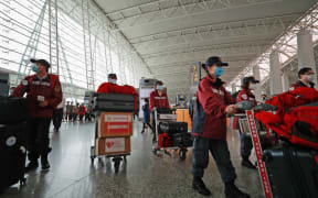 (200321) -- GUANGZHOU, March 21, 2020 (Xinhua) -- Members of Chinese anti-epidemic expert team to Serbia walk to the boarding gate at Guangzhou Baiyun International Airport in Guangzhou, capital of south China's Guangdong Province, March 21, 2020.