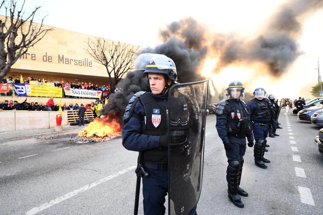 Riot police stand guard in front of the Baumettes prison in Marseille.
