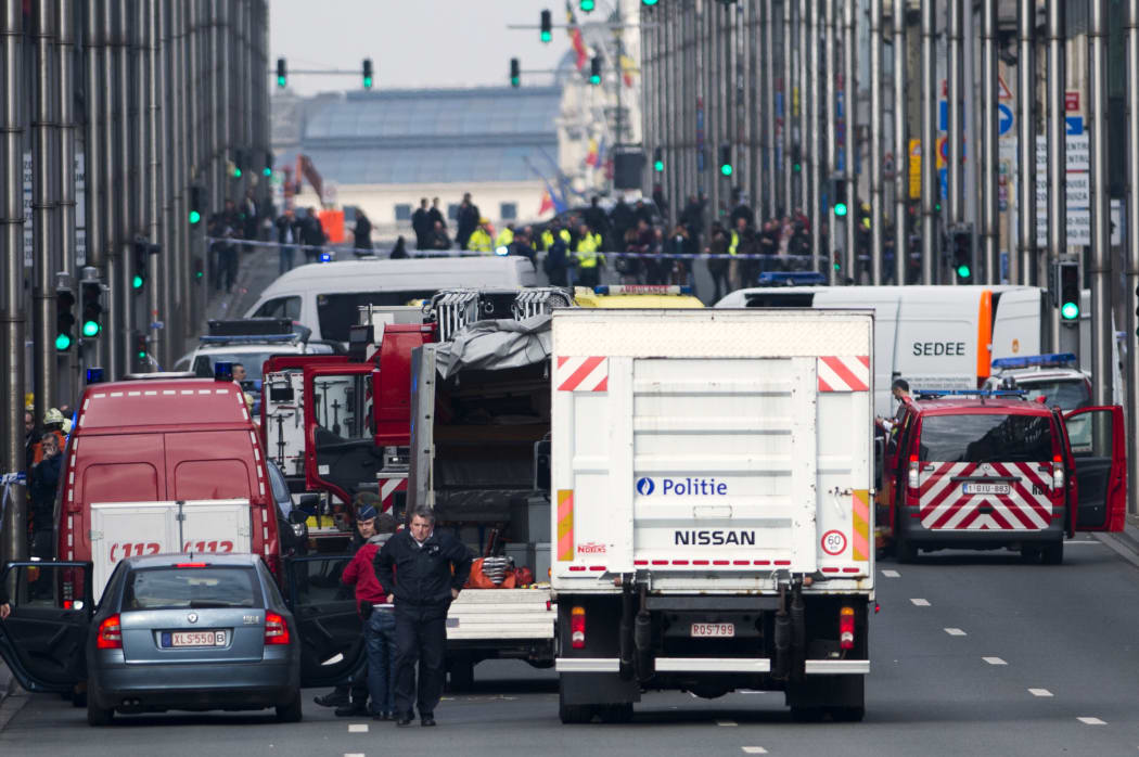 Belgian police on the Rue de la Loi, which has been evacuated after an explosion at the Maelbeek metro station in Brussels.