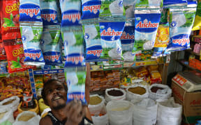 A Sri Lankan vendor sells New Zealand-made milk products in Colombo (August 2013).
