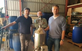 Michael Oelgemöller from James Cook University (right) at a distillery in New Caledonia.