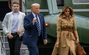 Barron Trump, left, with US President Donald Trump and Melania Trump pictured in August.