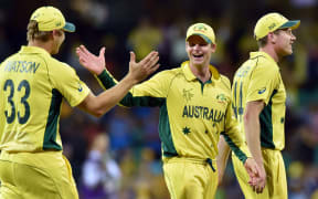 Steve Smith (centre) celebrates victory over India with Shane Watson (left) and James Faulkner (right).
