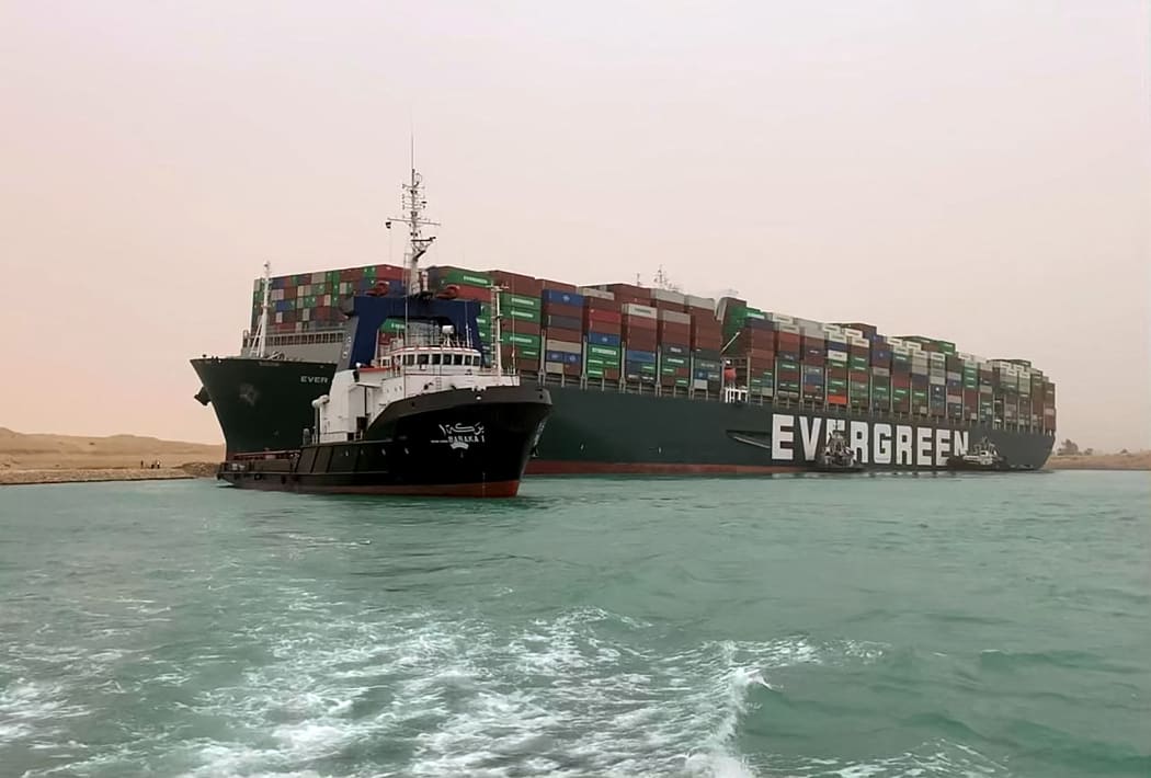 An image released by the Suez Canal Authority on 24 March 2021 shows 400m long container ship lodged sideways and impeding traffic across Egypt's Suez Canal.