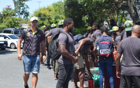 PNG Hunters Matt Church (L) watches on as players unpack their gear on the Gold Coast.