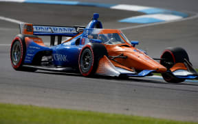IndyCar driver Scott Dixon (9) drives through turn 2 during practice for the IndyCar Harvest GP Race 1 at the Indianapolis Motor Speedway in Indianapolis, Indiana.