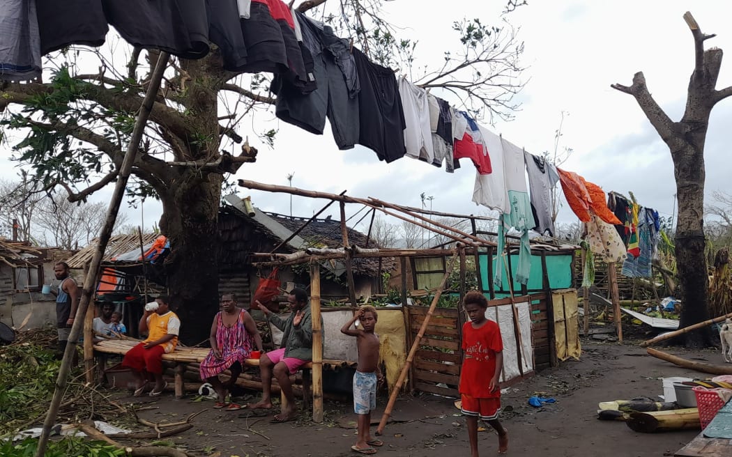 A Ni-Vanuatu family at the Blacksands community in Port Vila on Efate Island after Cyclone Kevin.