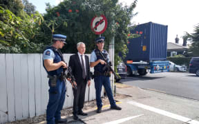 Phil Goff with armed police officers at Otahuhu.