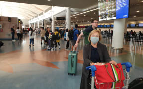 Passengers at Auckland Airport today.