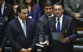 Jair Bolsonaro (R) swears in as Brazil's new President.