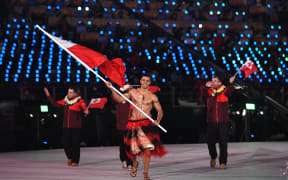 Tonga's flagbearer Pita Taufatofua leads his country's delegation.